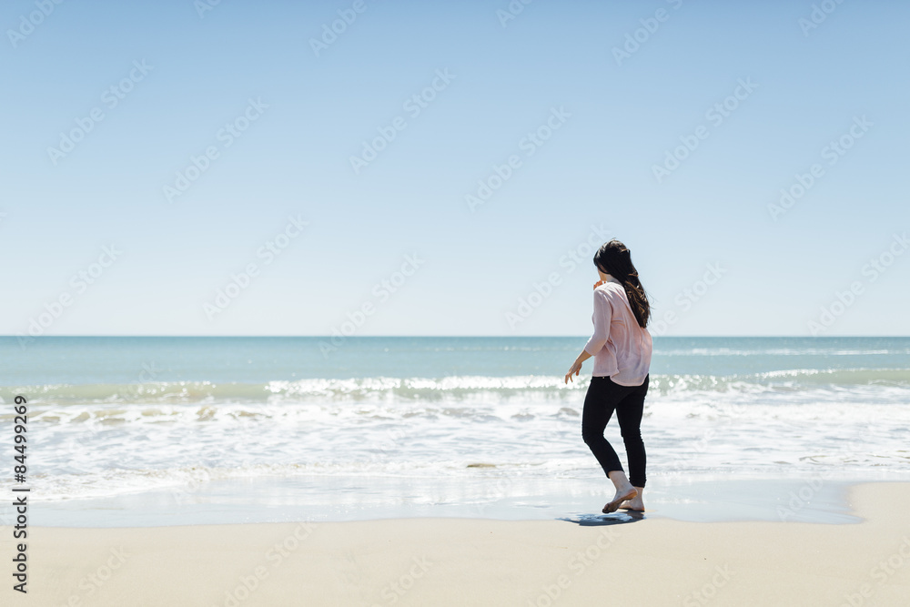 Young beautiful woman near the sea at spring