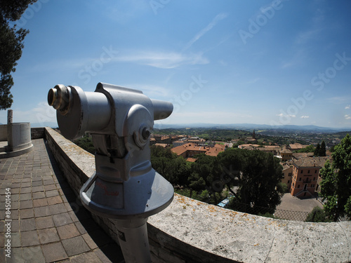 Telescope pointed at the scene of the medieval town of Perugia,