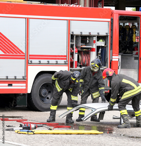 firefighters during a road accident with car parts