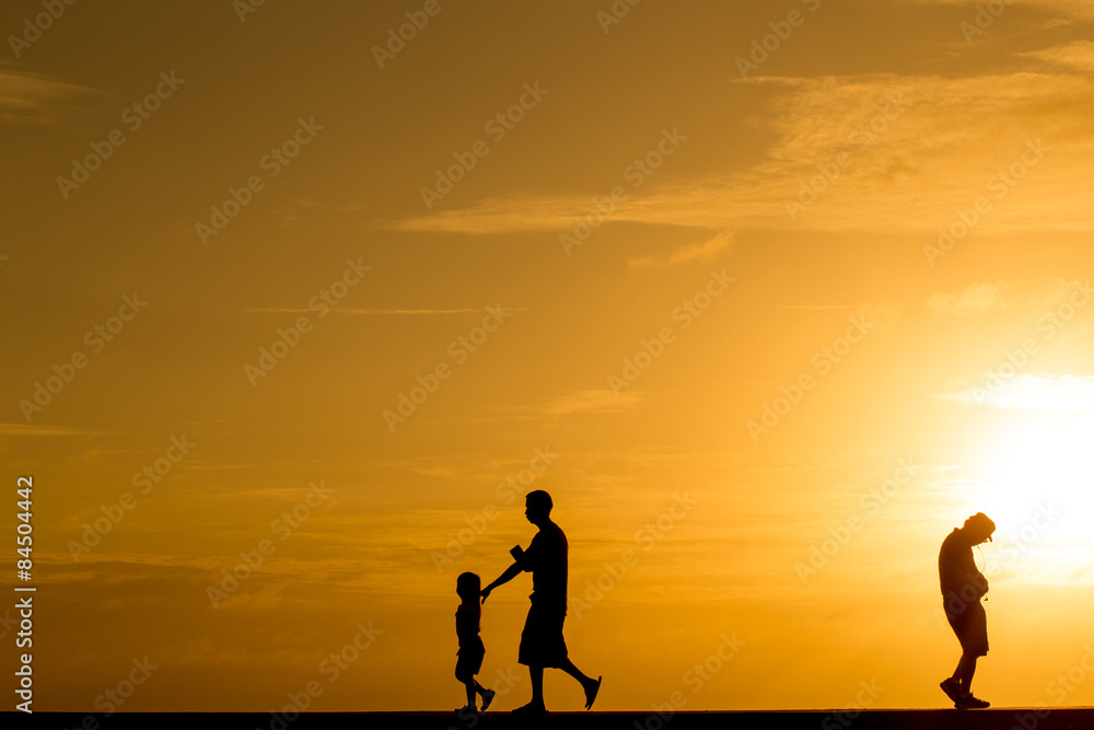 Silhouette people walking at sunset