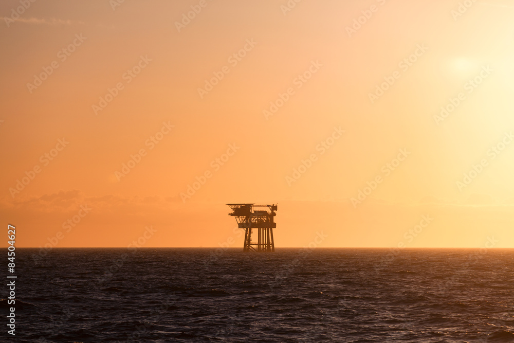 Silhouette of oil platform at sunset Silhouette of oil platform at sunset