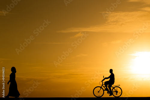 Silhouette man riding the bike at sunset © littlestocker