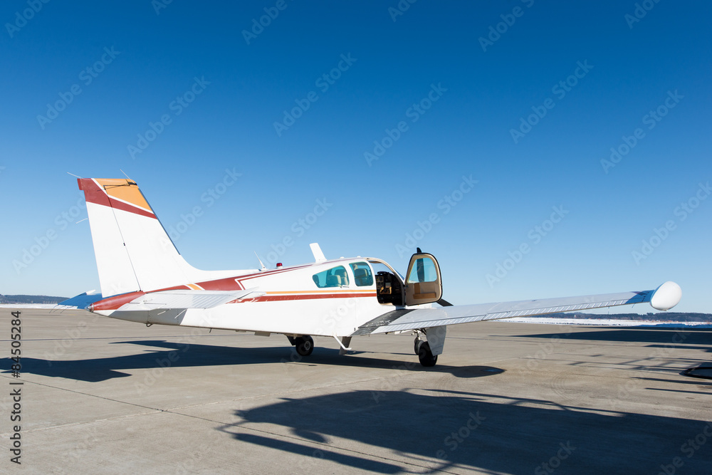opened door of small propeller-driven aircraft at airstrip opened door of small propeller-driven aircraft at airstrip