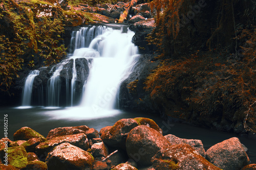 Fototapeta Naklejka Na Ścianę i Meble -  Waterfall with orange and red colours in the Gold Coast hinterlands.