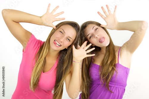Blonde teenagers making funny faces isolated
