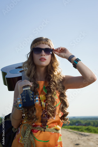 Romantic girl travelling with her guitar