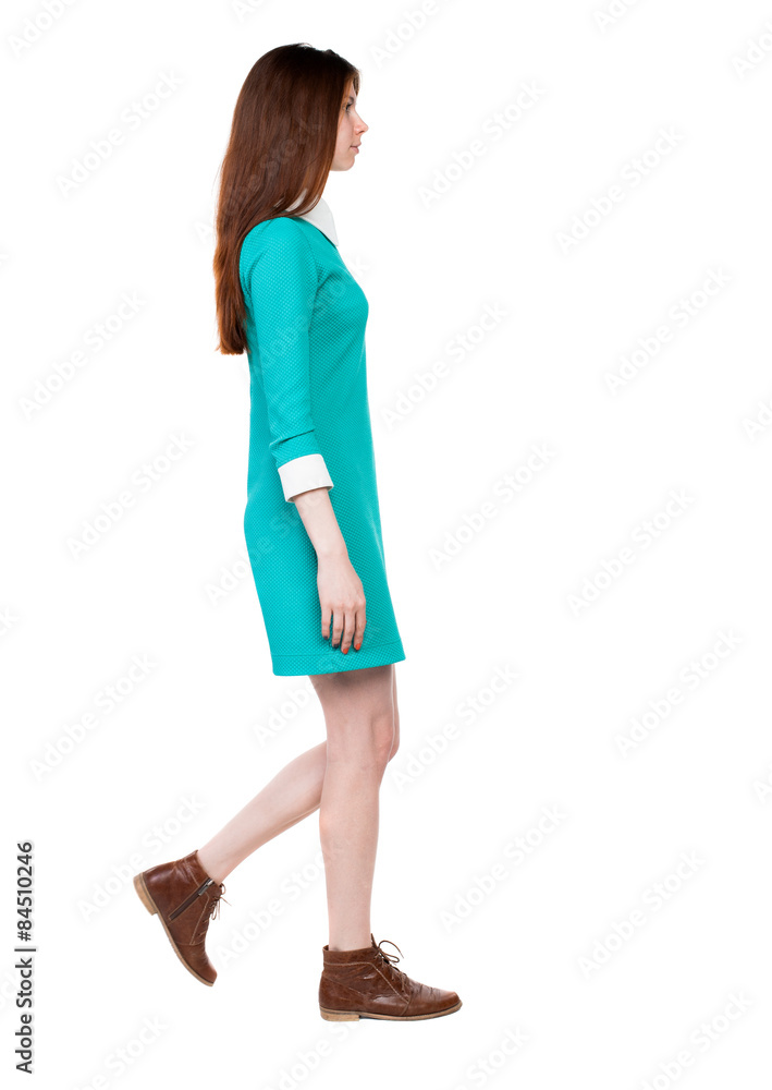 side view of walking woman in dress. side view of walking woman in dress.