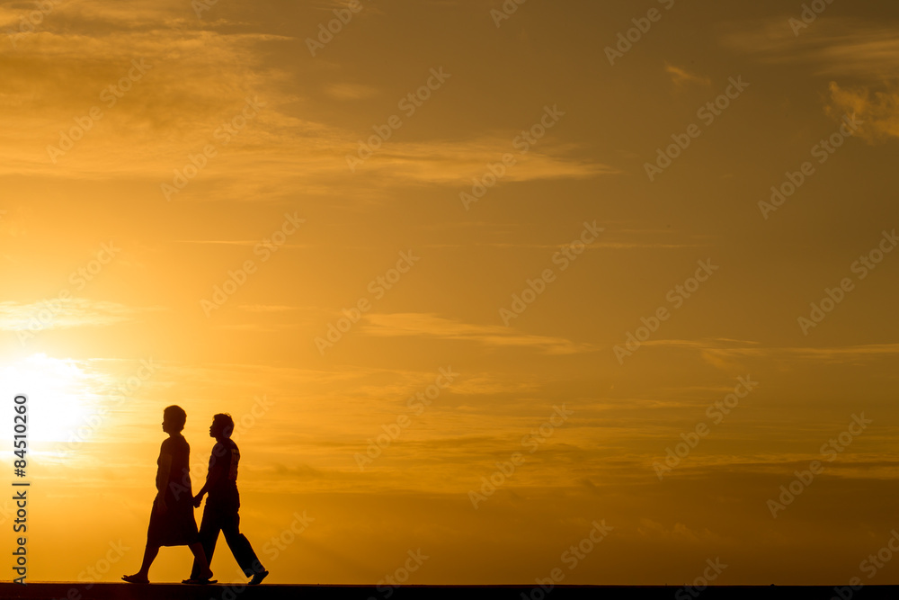 Silhouette people walking at sunset Stock Photo | Adobe Stock