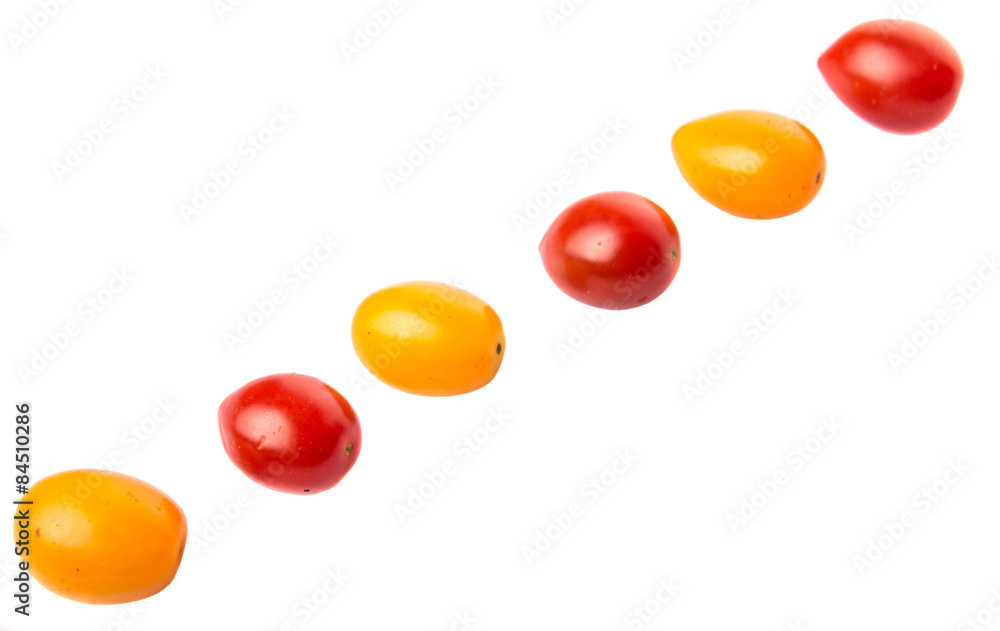 Yellow and red grape tomato over white background