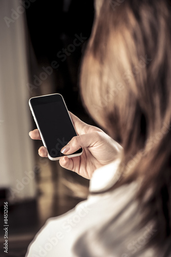 Woman holding smartphone photo