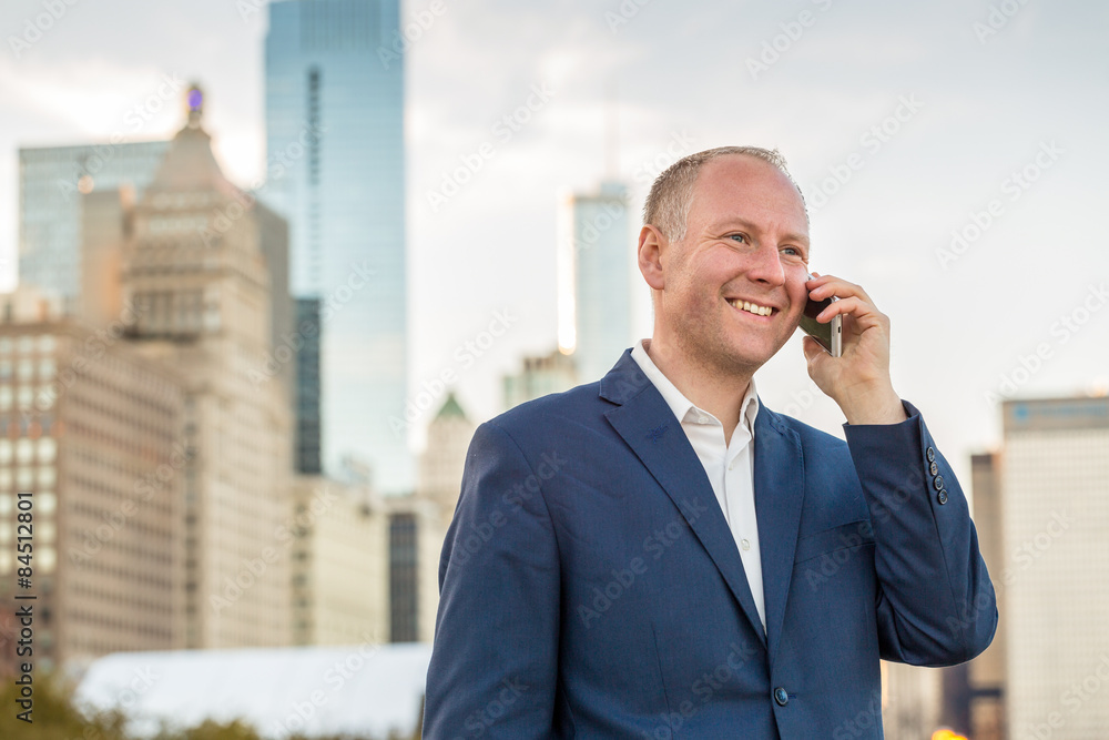 Businessman using phone outside the offices Businessman using phone outside the offices