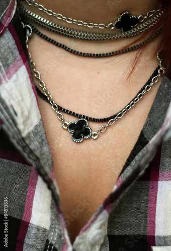 The woman decolette in plaid shirt with black and silver necklace
