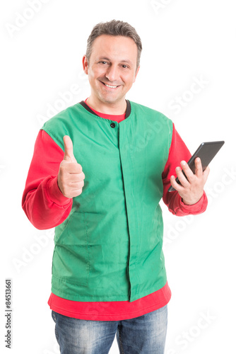 Friendly supermarket employee using wireless tablet