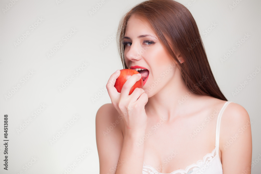 beautiful girl eating red apple and smiles beautiful girl eating red apple and smiles