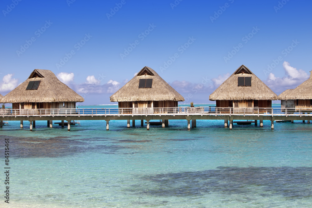 typical landscape of tropical islands - huts, wooden houses over water