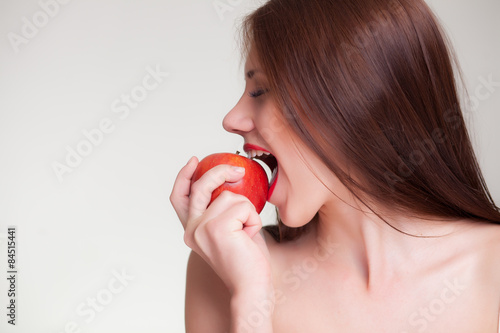 beautiful girl eating red apple