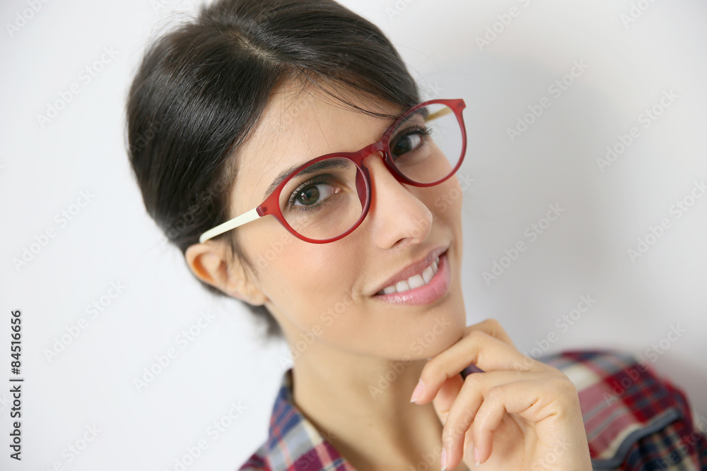 Portrait of brunette girl with red eyeglasses on, isolated Portrait of brunette girl with red eyeglasses on, isolated