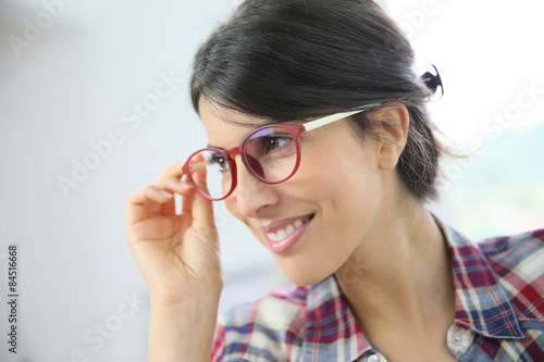 Portrait of brunette girl with red eyeglasses on  isolated