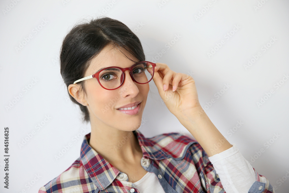 Portrait of brunette girl with red eyeglasses on, isolated Portrait of brunette girl with red eyeglasses on, isolated