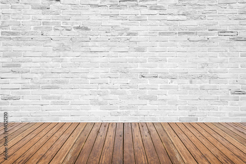 Old interior room with brick wall and wood floor