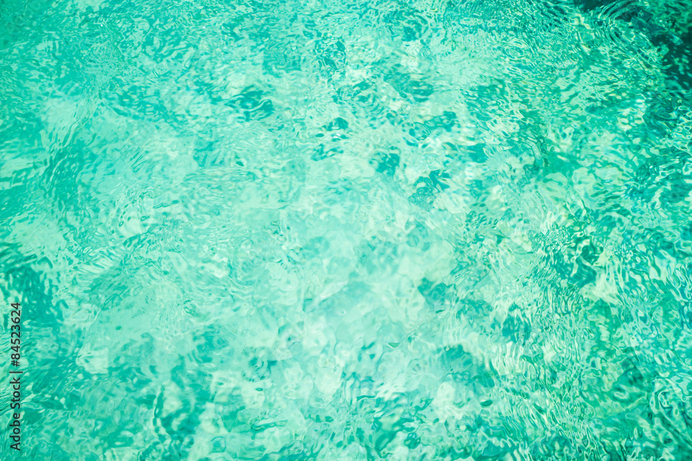 Rippling water in a pool. Bright green water background Rippling water in a pool. Bright green water background