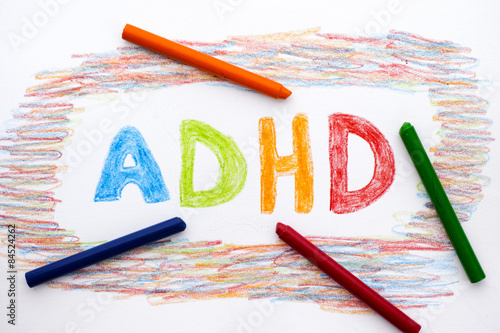 ADHD written on sheet of paper photo