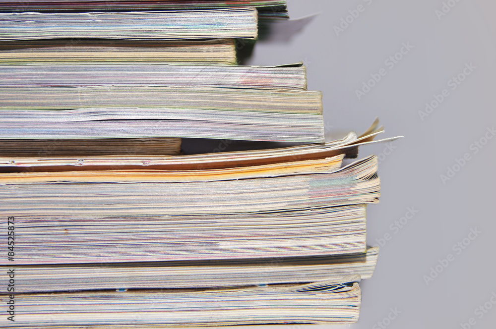 pile of old magazines and books close up pile of old magazines and books close up