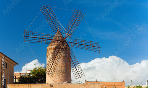 Old style windmill on the blue sky. Majorca, Spain