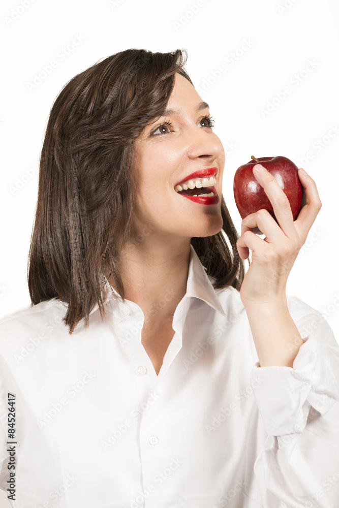 Beautiful young woman eating an red apple, studio shot on white Beautiful young woman eating an red apple, studio shot on white