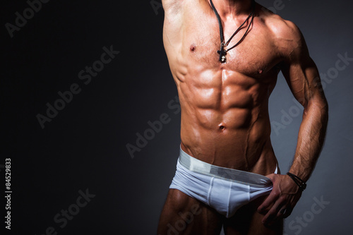 Tableau sur toile Muscular and sexy torso of young sport man with perfect abs in