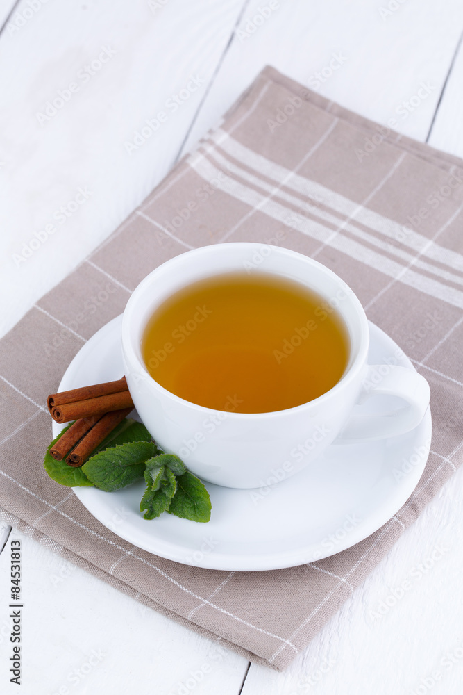 Mint tea with cinnamon on wooden table. Mint tea with cinnamon on wooden table.