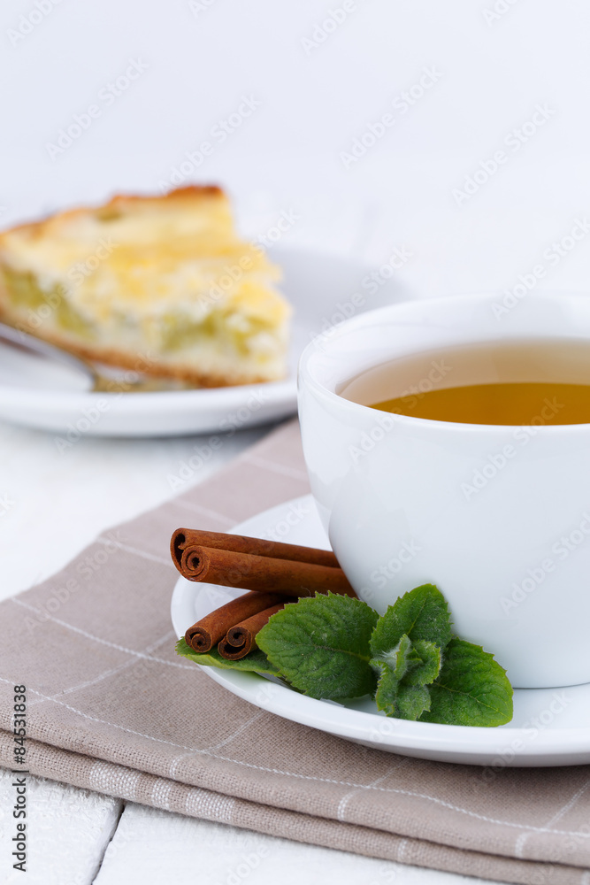 Mint tea with cinnamon on wooden table. Mint tea with cinnamon on wooden table.
