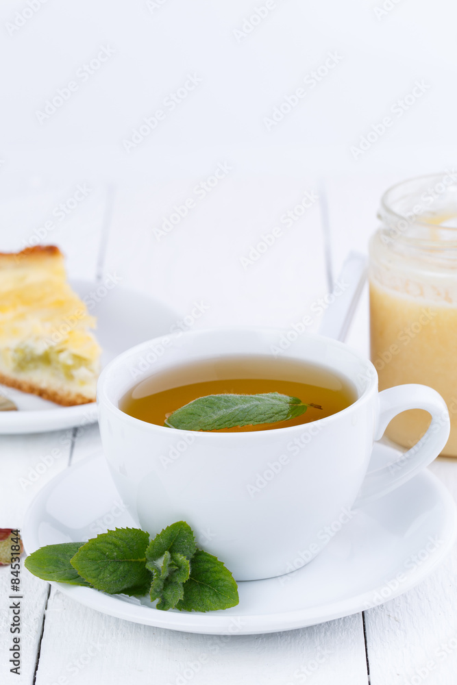 Mint tea with slice of rhubarb pie on wooden table. Mint tea with slice of rhubarb pie on wooden table.