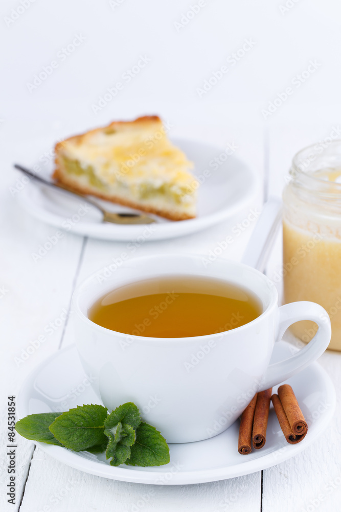 Mint tea with cinnamon on wooden table. Mint tea with cinnamon on wooden table.