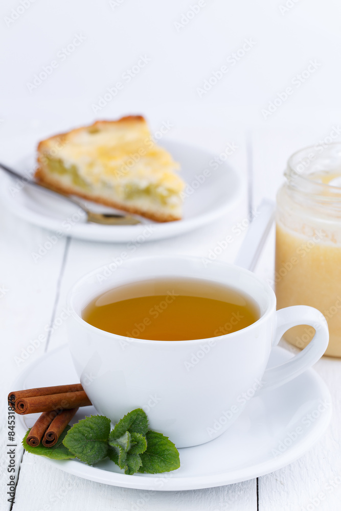 Mint tea with cinnamon on wooden table. Mint tea with cinnamon on wooden table.