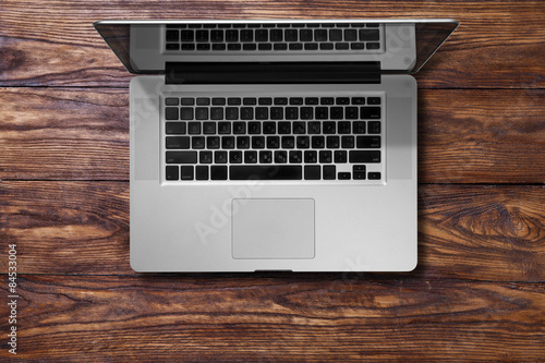 Obraz na płótnie Open laptop on brown wooden table