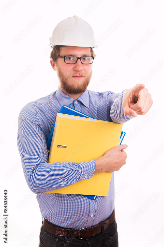 Young happy engineer in helmet pointing with finger Young happy engineer in helmet pointing with finger
