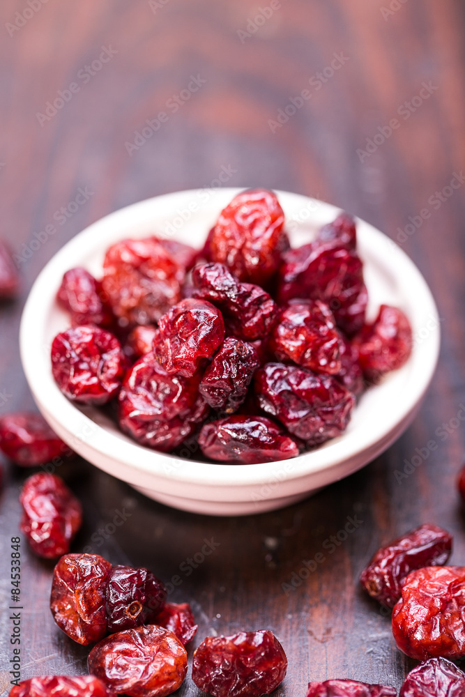dried cranberries in a wooden spoon. fruit full of vitamin c. dried cranberries in a wooden spoon. fruit full of vitamin c.