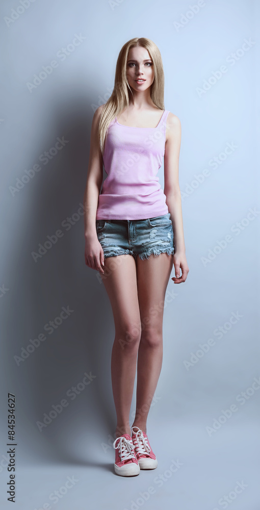 Expressive young model in casual style on gray background Expressive young model in casual style on gray background