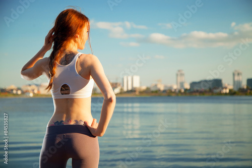 athletic woman in the background the city and the river.