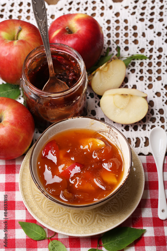 Apple jam and fresh red apples on wooden table close-up Apple jam and fresh red apples on wooden table close-up