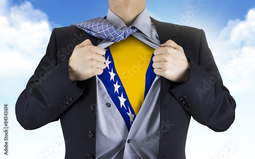 businessman showing Bosnia and Herzegovina flag underneath his s photo