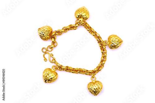 Gold bracelet over white background