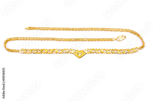 Gold necklace over white background