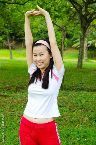 Young pretty asian woman in sports outfit stretch her hands