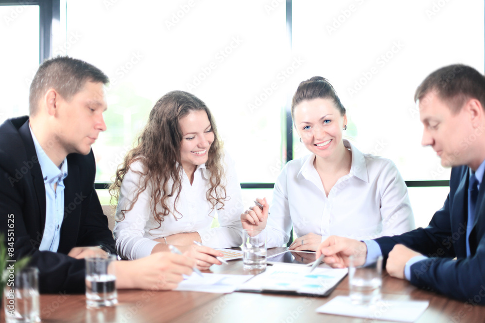 Image of business partners discussing documents and ideas at meeting Image of business partners discussing documents and ideas at meeting