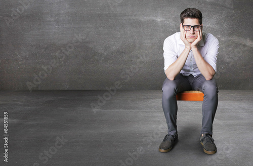 bored worker on little chair