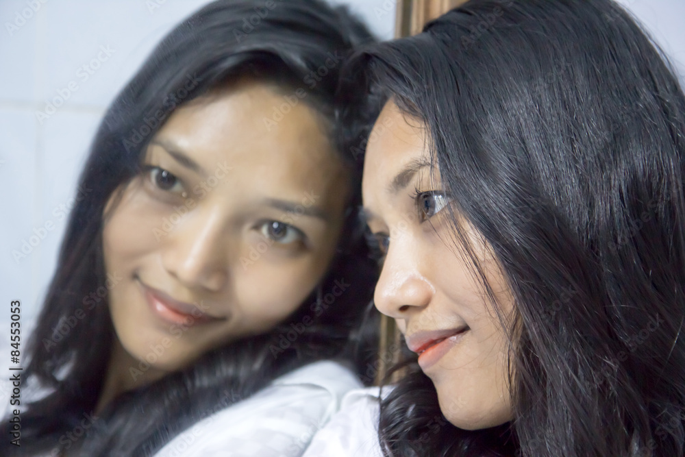 face of a woman is reflected in a mirror face of a woman is reflected in a mirror