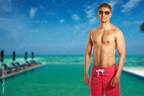 Man at tropical swimming pool