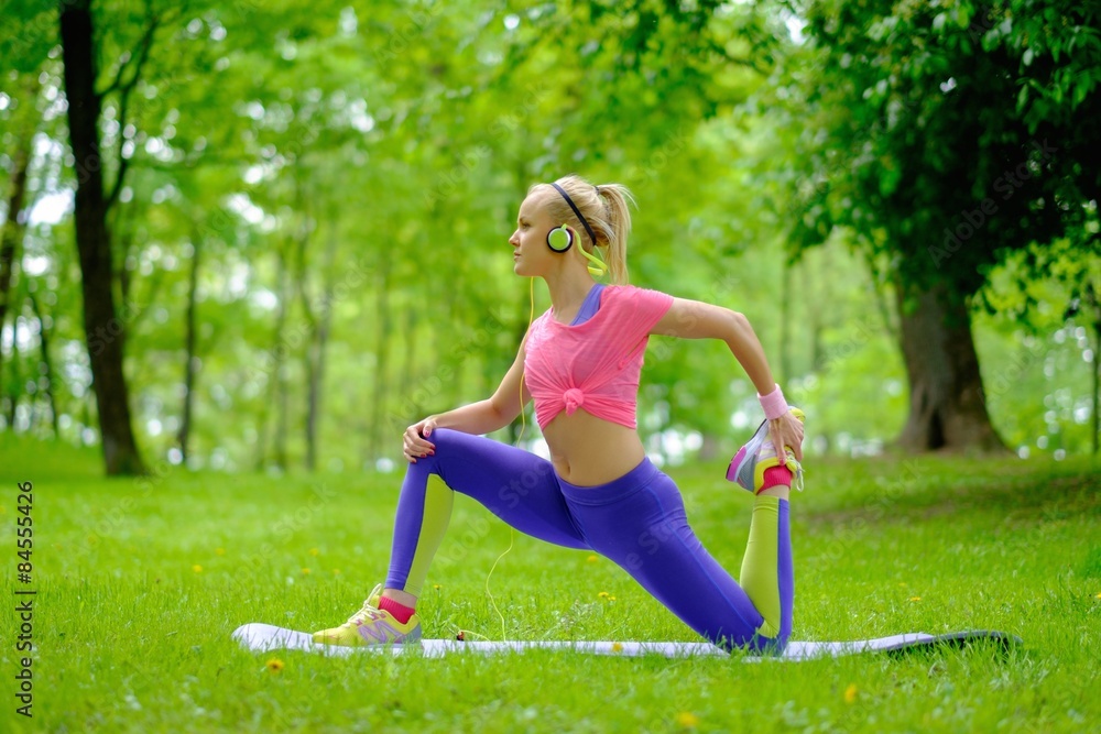 Sporty woman doing fitness exercises outdoors Sporty woman doing fitness exercises outdoors